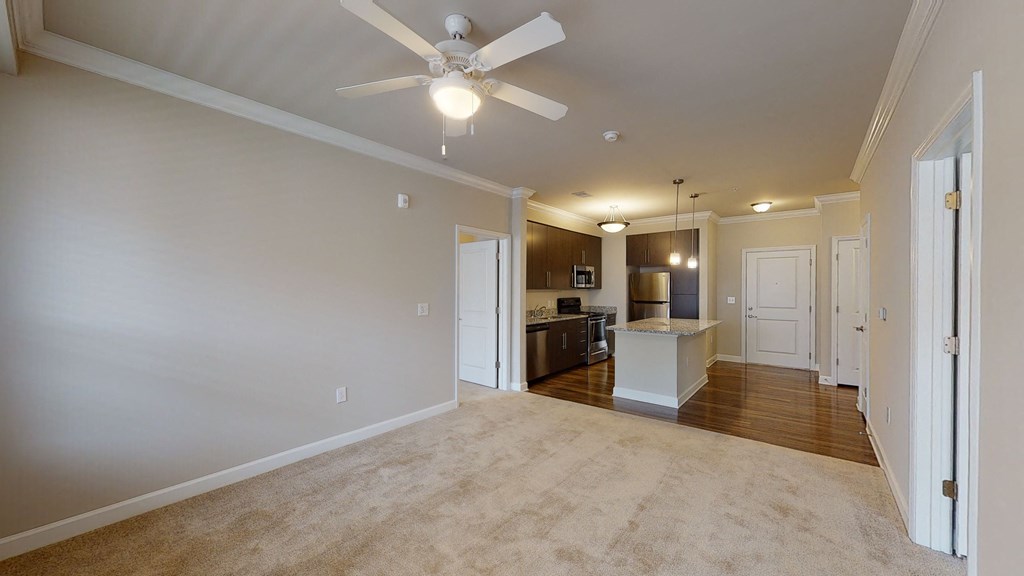 Living room with ceiling fan; open to kitchen