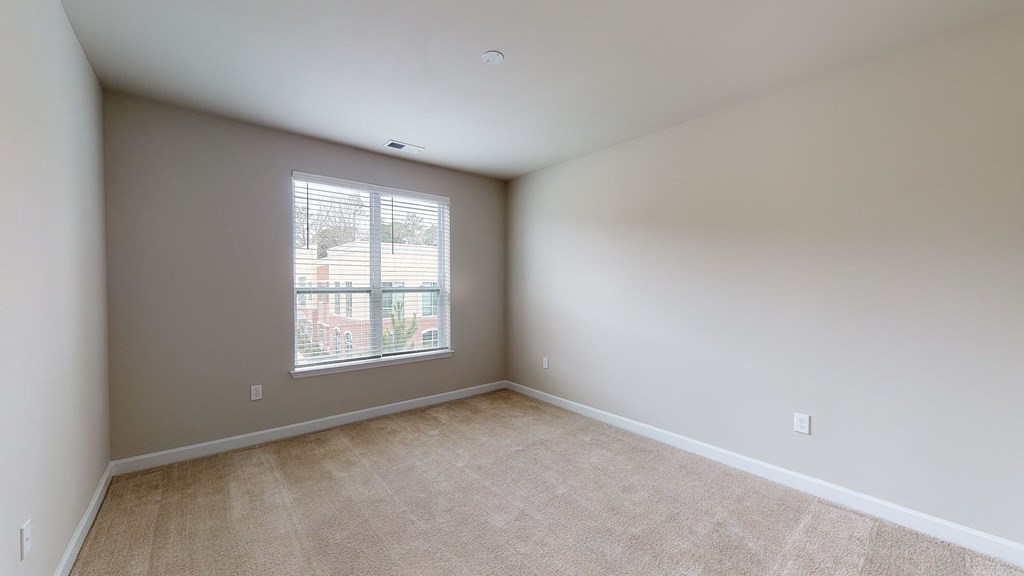 Bedroom with window; carpet