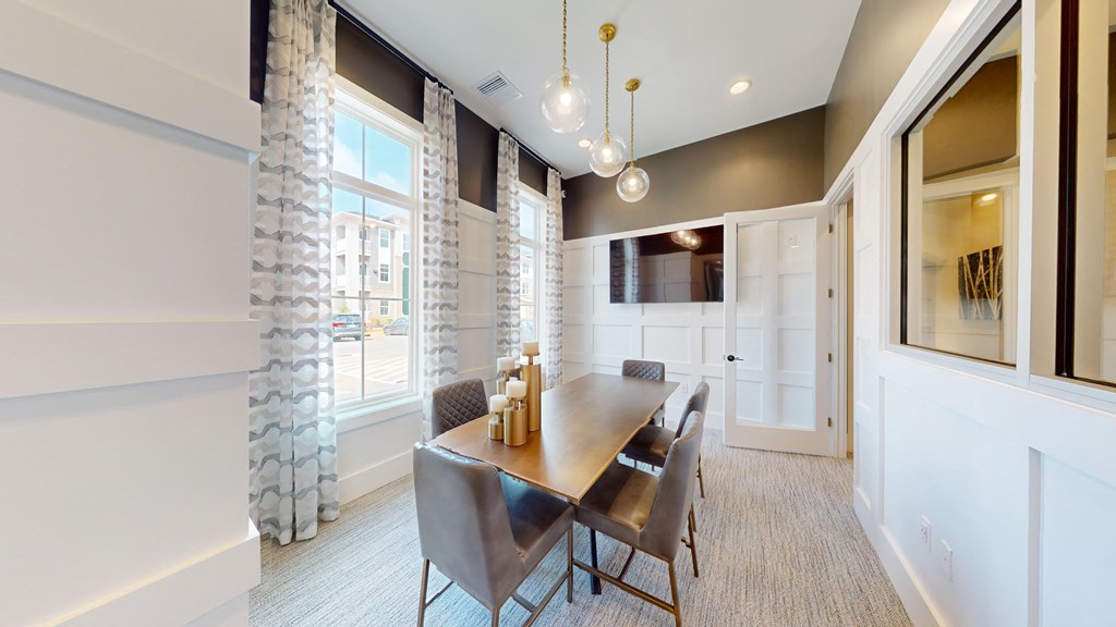 a dining room with a wooden table and chairs and a large window