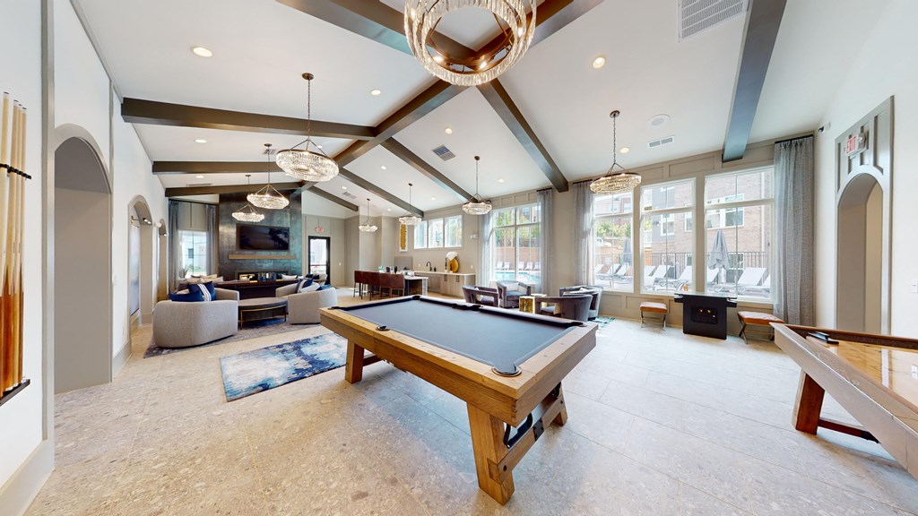 a game room with a pool table and couches