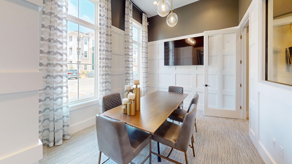 A dining room with a table and chairs.