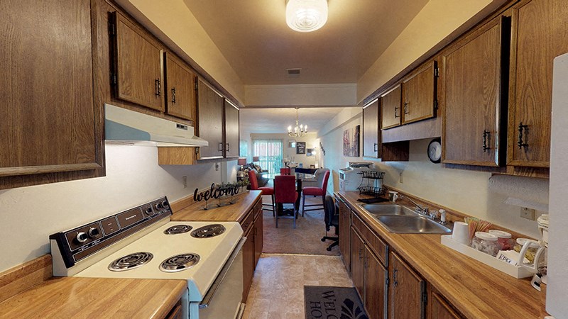 a kitchen with a stove and a sink and a table