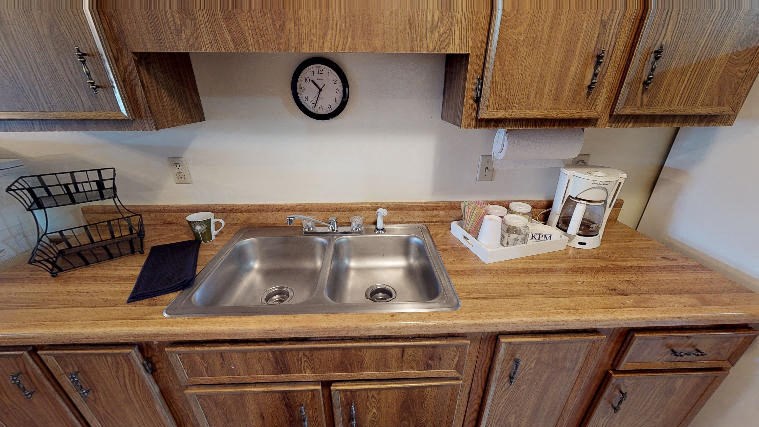 a kitchen with a sink and cabinets in it