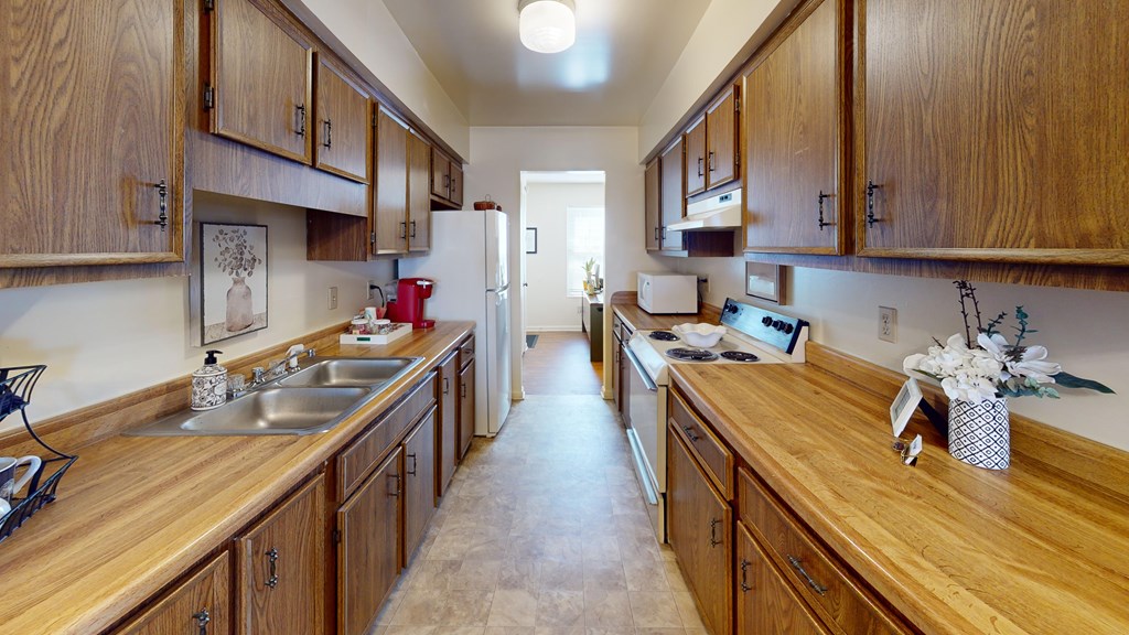 Kitchen a galley style kitchen with a refrigerator and stove
