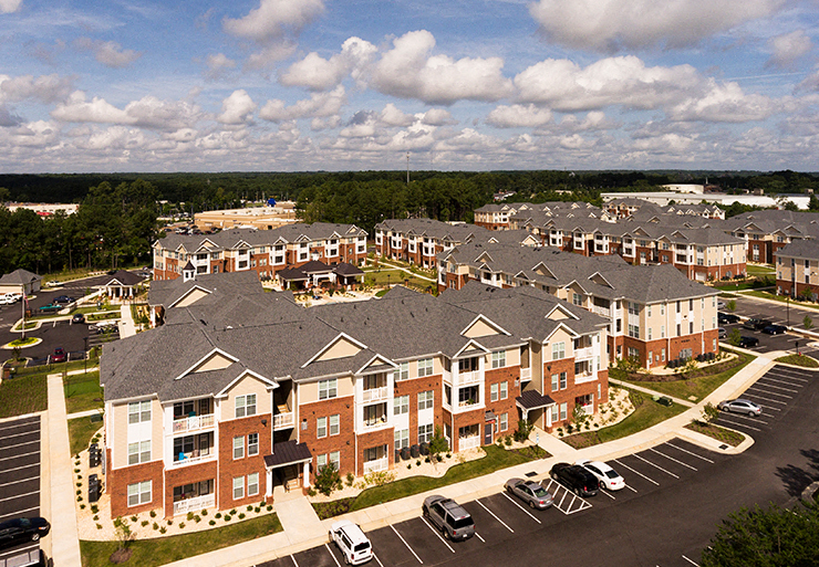 Aerial view of apartment buildings and parking lot