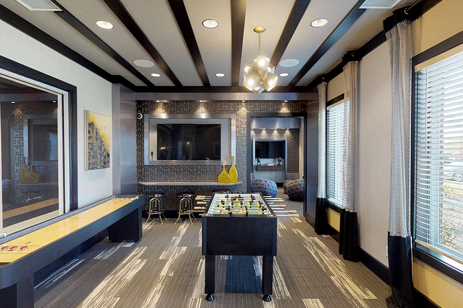 Game room with foosball table, shuffleboard, flat screen TVs