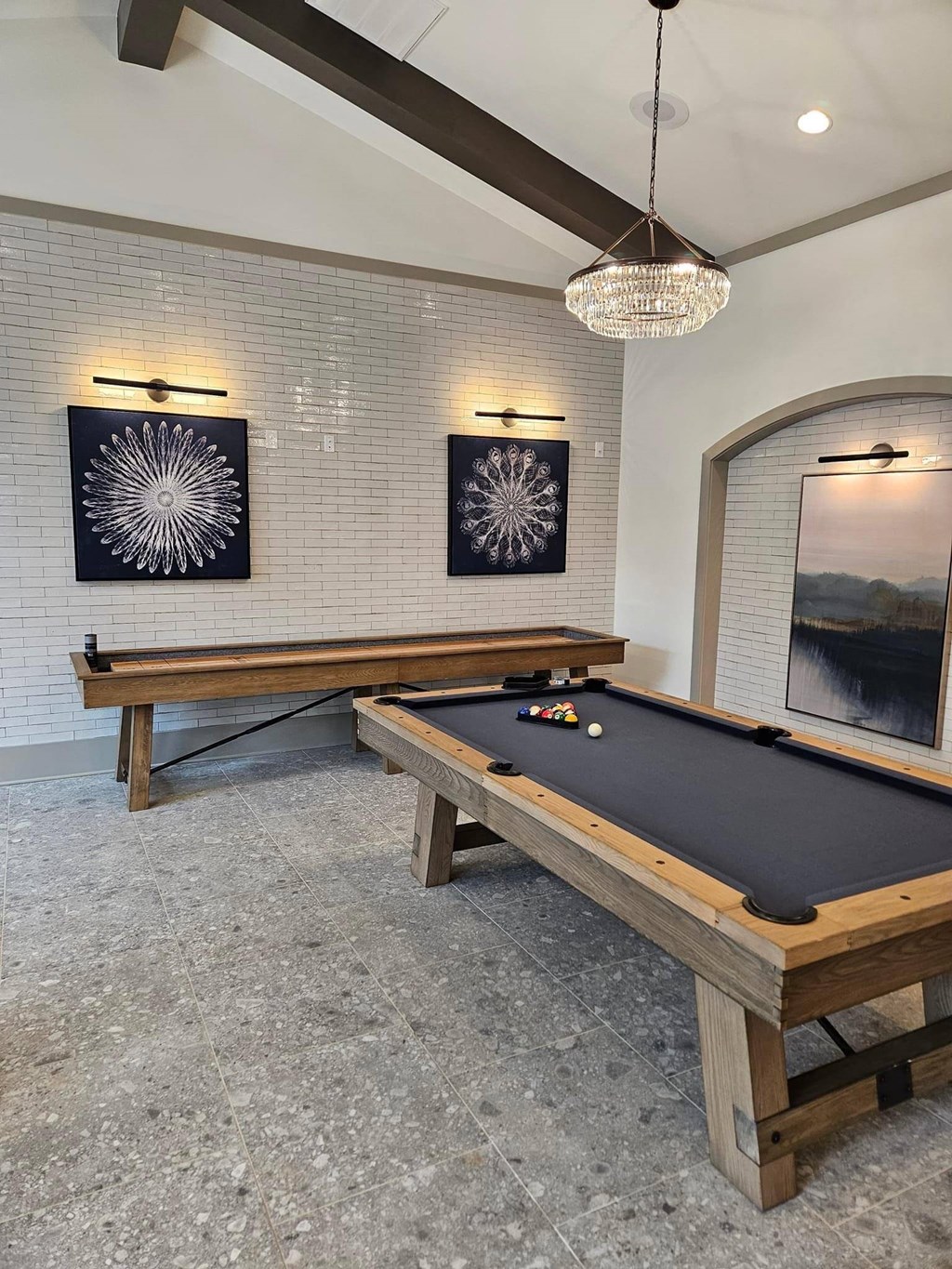 a pool table in a game room with two tables
