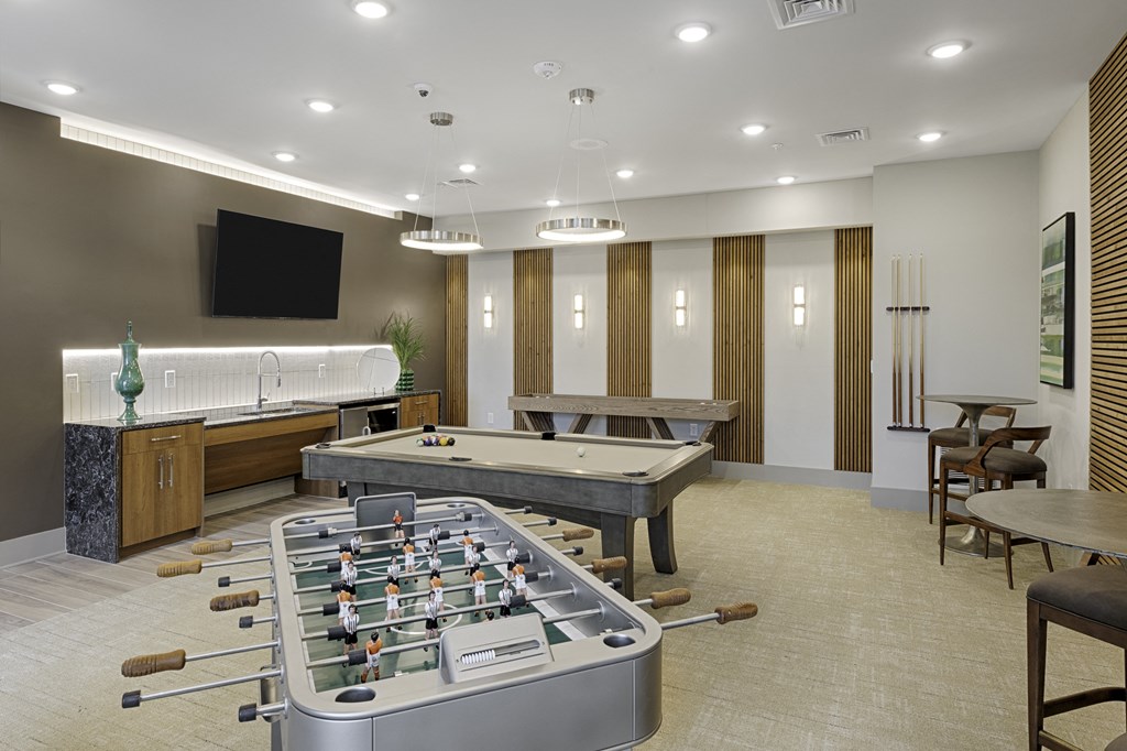 Game room with foosball table, billiards, shuffleboard, flat screen TV