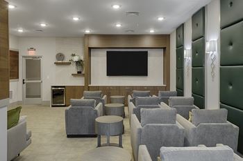 Theater room with flat-screen TV, tables and separate chairs