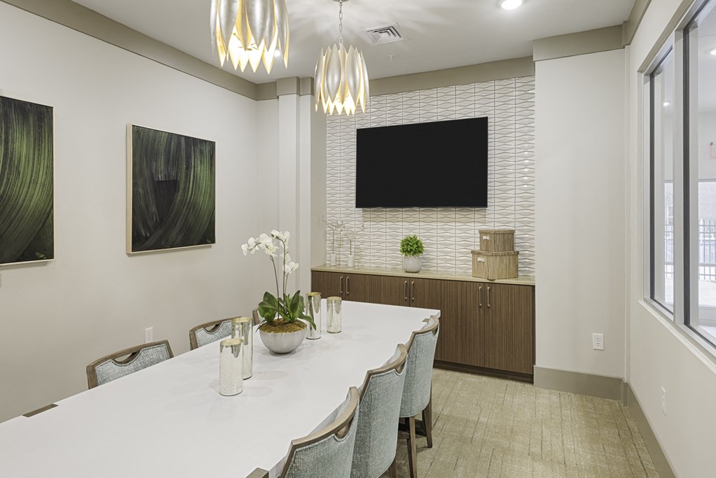 Conference and meeting room inclubhouse with long table, chairs and TV