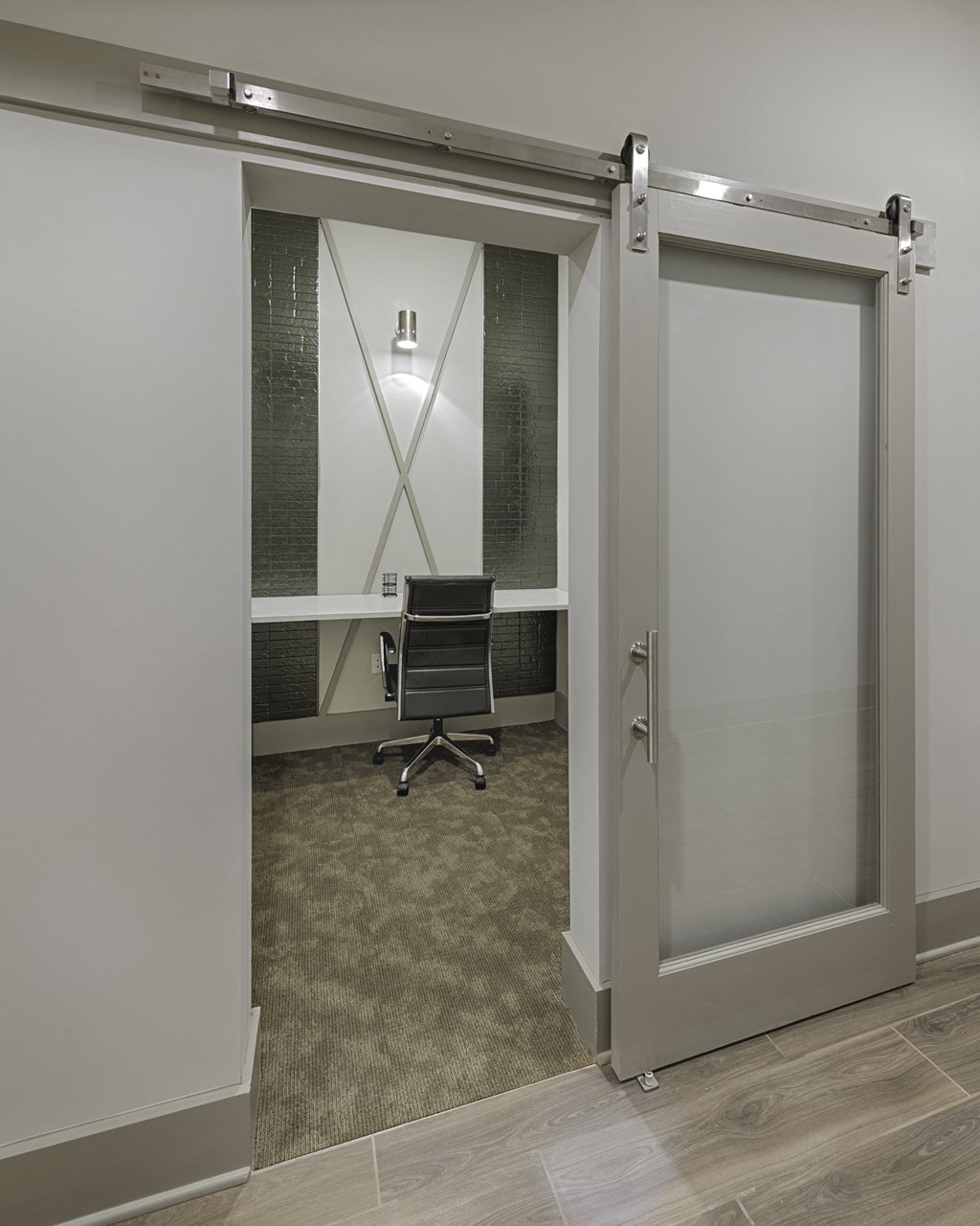 Work space in clubhouse with desk and sliding door