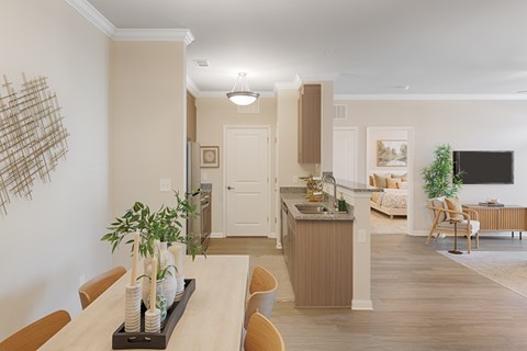 A kitchen with a dining table and chairs in the foreground.
