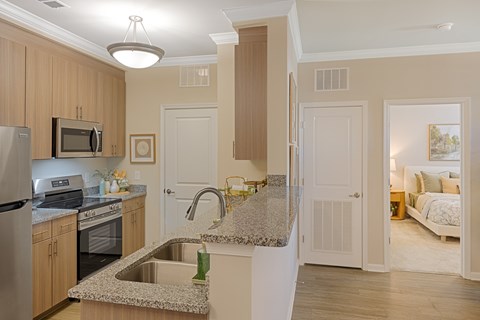 A kitchen with a granite counter top and a sink.