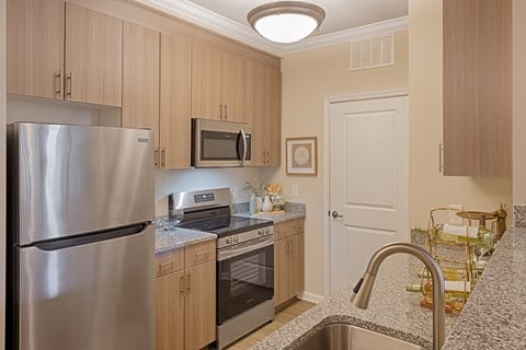 A kitchen with a stainless steel refrigerator and microwave.