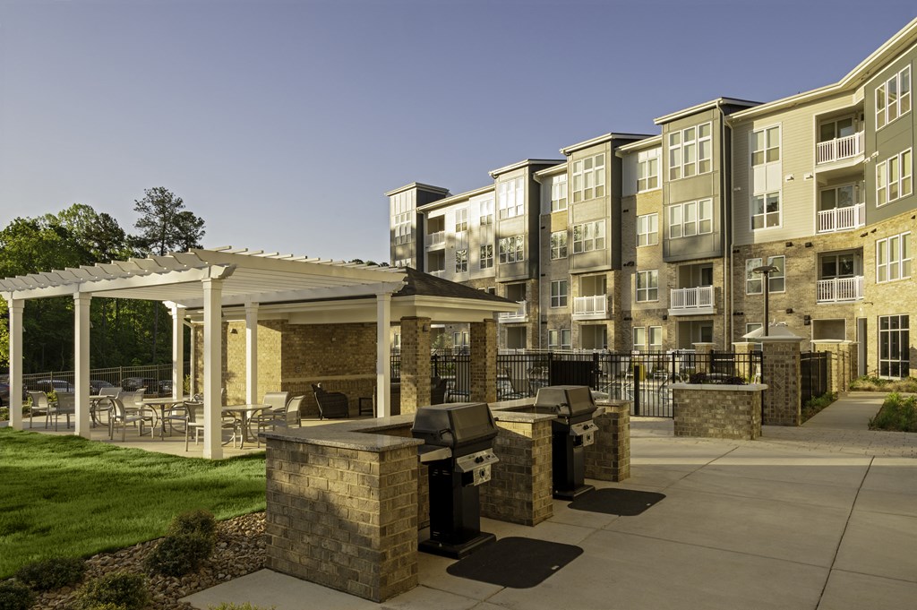Poolside entertaining area with grills and covered seating