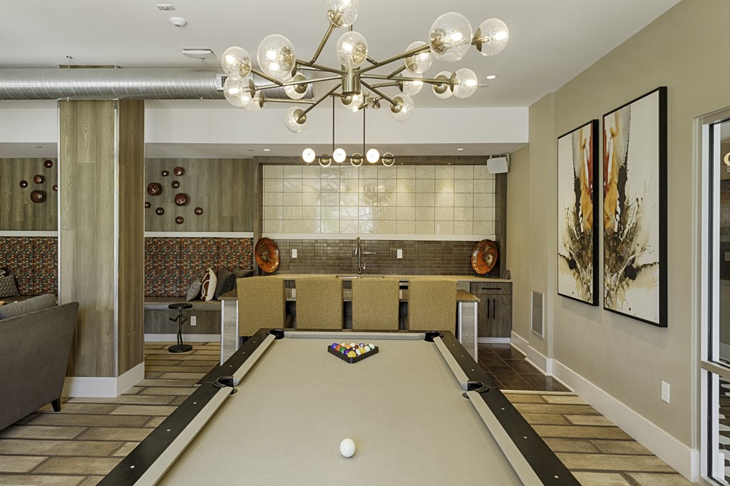 Game room with billiards and bar area with seating