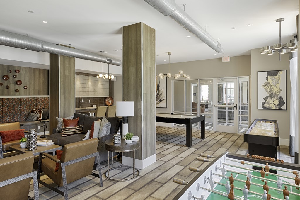 Game room with foosball table, billiards, shuffleboard, flat screen TV and seating