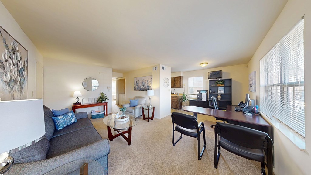 A living room with a grey couch, a coffee table, and a television.