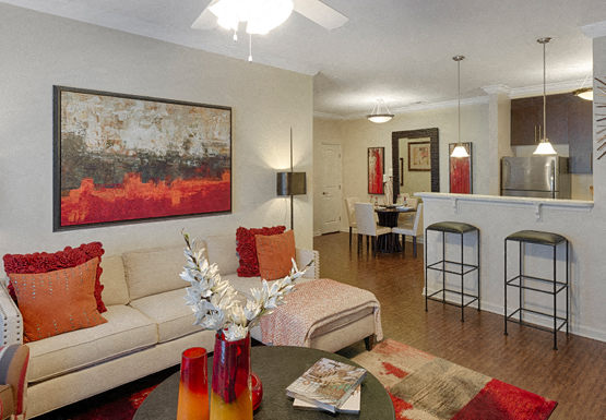 Living room with couch; open to kitchen and dining room