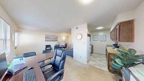 A conference room with a wooden table and chairs.