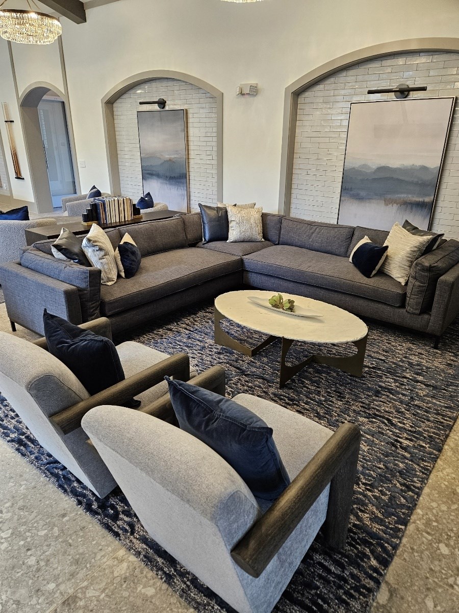 a living room with couches and chairs and a table