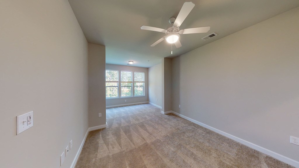Bedroom with sunroom; carpet; ceiling fan