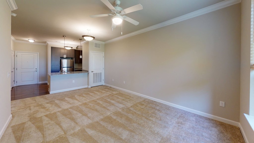 Living room with carpet; ceiling fan; open to ktichen