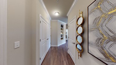 Hallway leading to kitchen and living area; vinyl plank floors