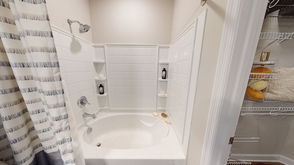 Soaking tub in bathroom; linen closet