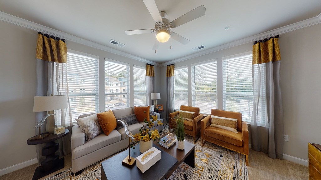 Living room with windows, ceiling fan, carpet