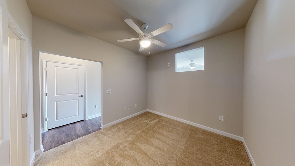 Bedroom with ceiling fan; sliding door; carpet