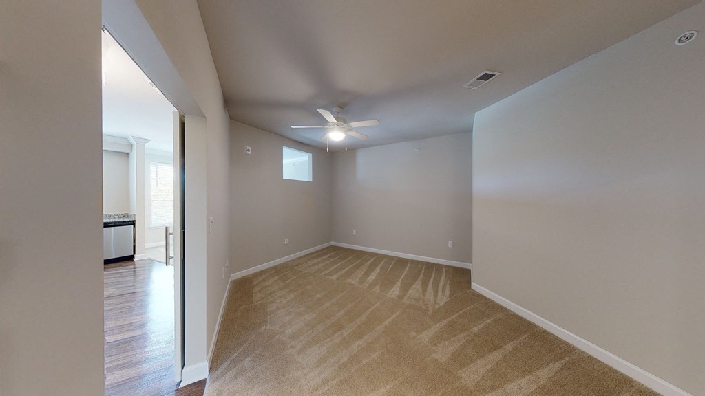 Bedroom with ceiling fan; small window to living room