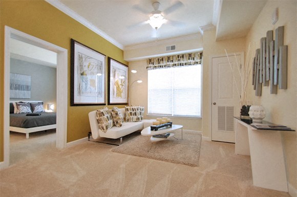 Living room with couch; window; bedroom off living room