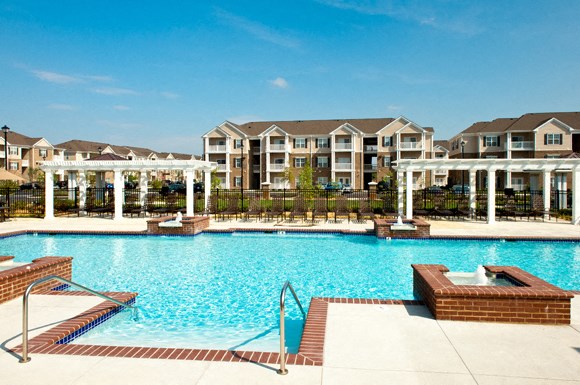 Resort-style pool with pergolas, fountains and chairs