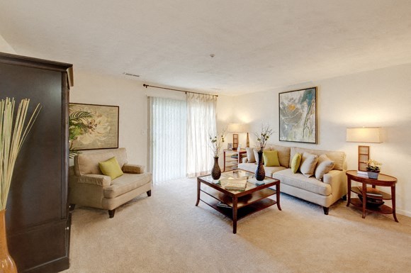 Living room with sofa and chair; door to patio or balcony