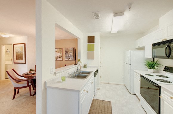 Kitchen and Dining Room Galley kitchen with white cabinets; separate dining area