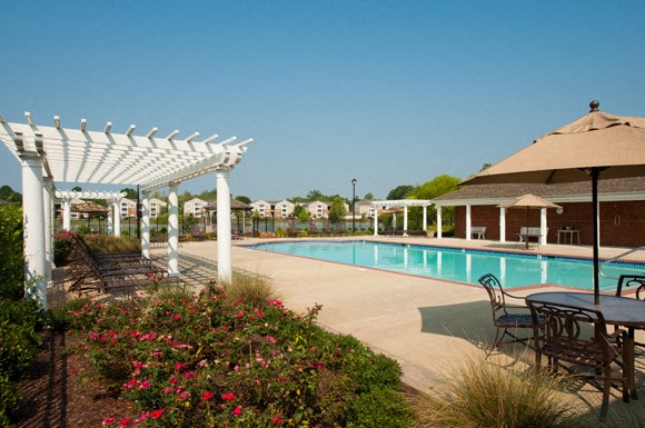 Pool With Cabanas and Chairs