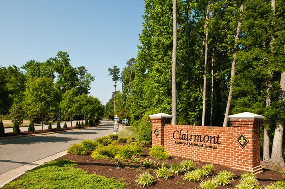 Clairmont at York Apartments Tree-lined street with Clairmont Apartments sign leading into the community