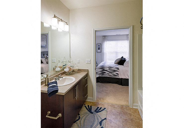 Bathroom with sink, toilet, shower and tub; inside bedroom