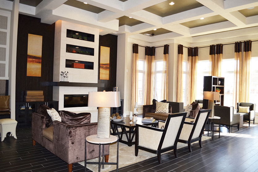 a living room with a couch and chairs and a table