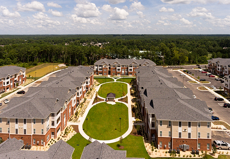 Aerial view of apartment buildings with paved pathways throughout