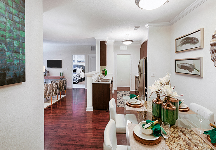 a living room and dining room with a table and chairs