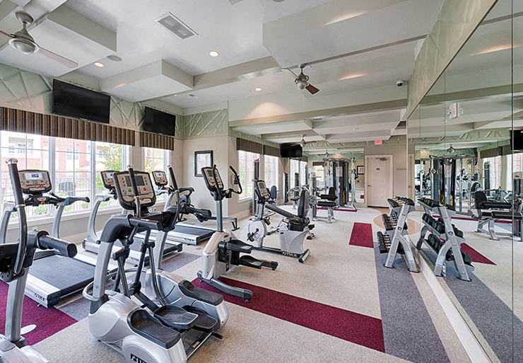 Fitness center with cardio equipment; flat screen TV