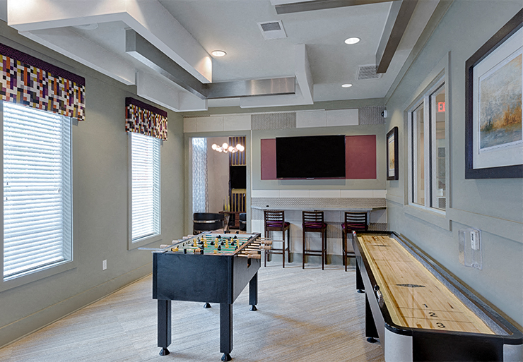 Game room with foosball table, shuffleboard, flat screen TVs