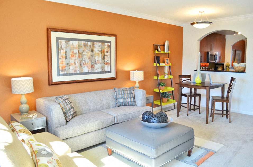 Living Room with couch; dining table with two chairs; opening to kitchen