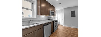 A modern kitchen with wooden cabinets and stainless steel appliances.