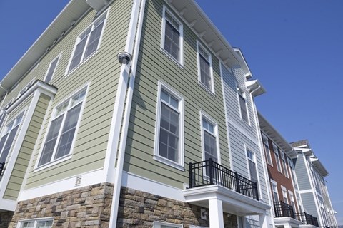 A multi-story building with a balcony on the second floor.