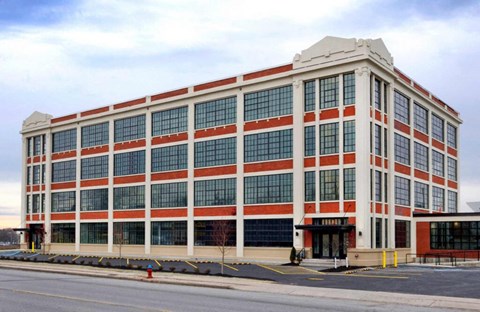 A large red and white building with many windows.