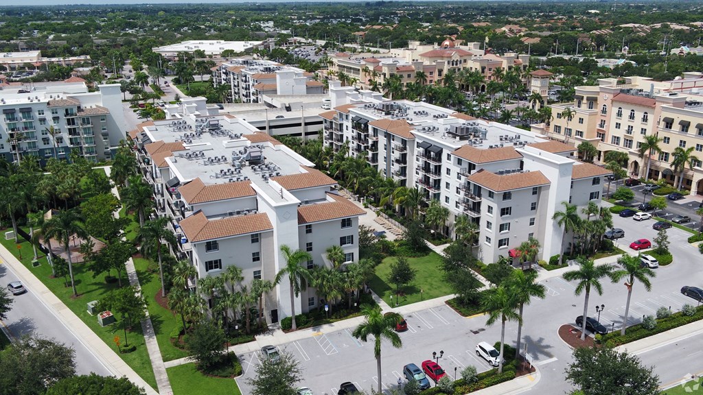 A large apartment complex surrounded by palm trees.