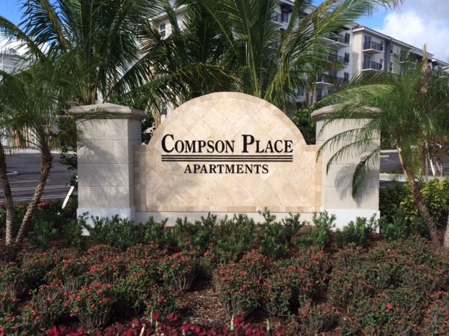 A sign that says Compson Place Apartments.